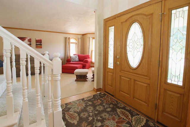 foyer featuring light hardwood / wood-style floors and crown molding