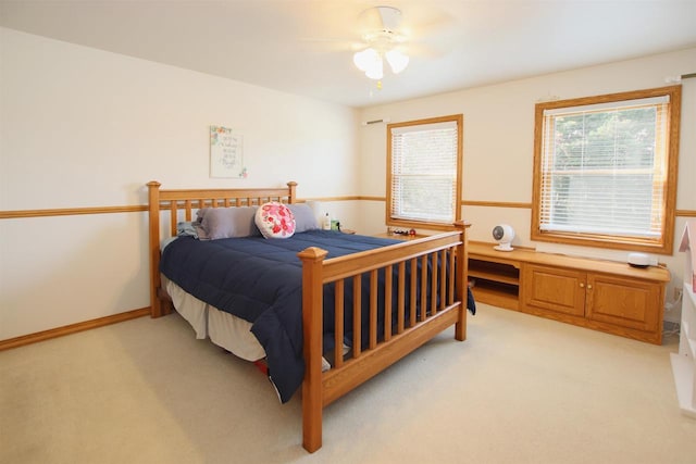 bedroom with ceiling fan and light colored carpet