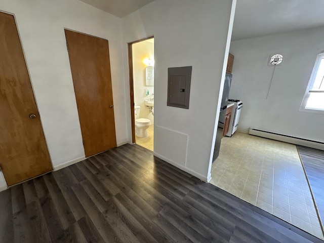 interior space featuring a baseboard heating unit, electric panel, and dark wood-type flooring