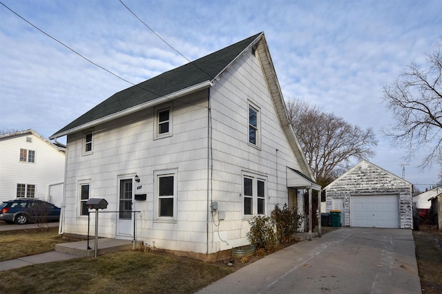 view of front of property with a garage and an outbuilding