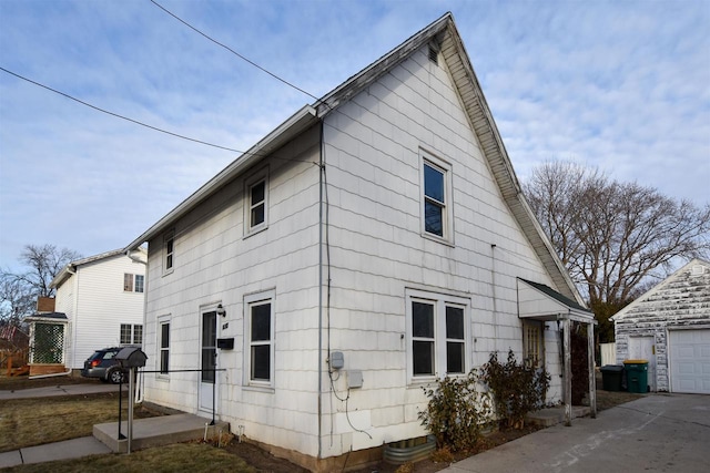 view of side of home featuring an outbuilding and a garage