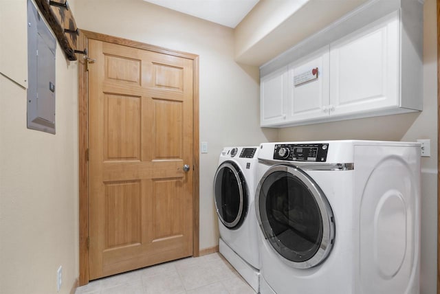 clothes washing area with washer and dryer and cabinets