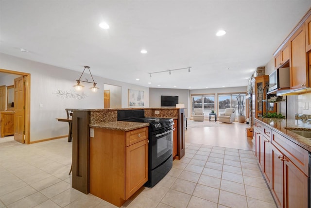 kitchen with black range with electric cooktop, light tile patterned flooring, light stone counters, and decorative light fixtures