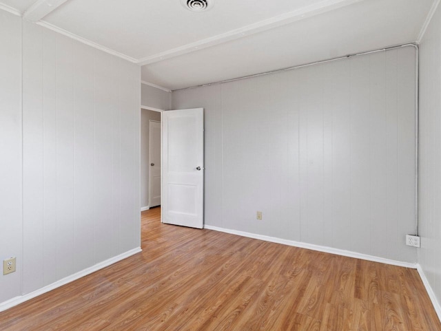 empty room with light hardwood / wood-style flooring and ornamental molding