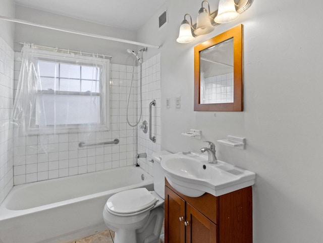 full bathroom featuring vanity, toilet, and tiled shower / bath