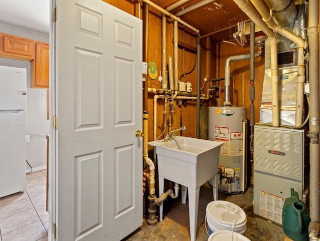 utility room featuring gas water heater and sink