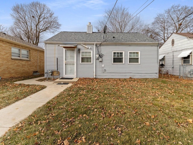 back of house with a lawn