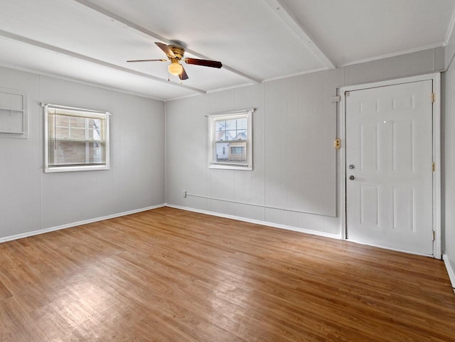 spare room with ceiling fan, crown molding, and wood-type flooring