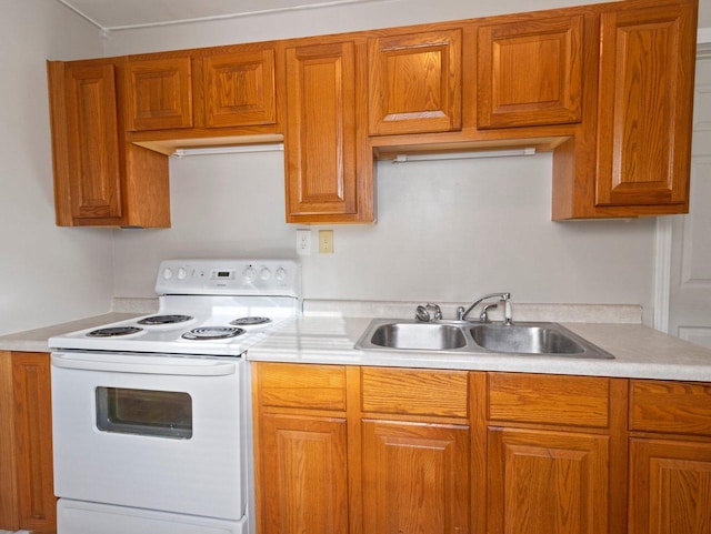 kitchen featuring white electric range oven and sink