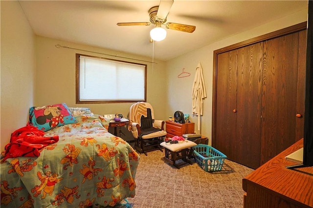 carpeted bedroom featuring ceiling fan and a closet