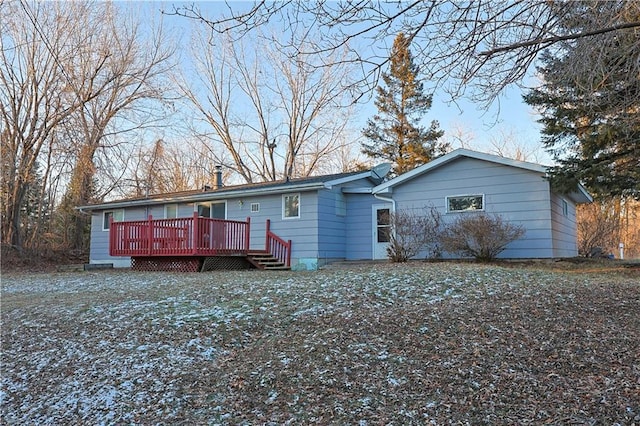 back of house featuring a wooden deck