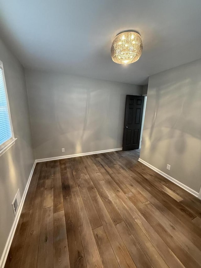 spare room featuring wood-type flooring