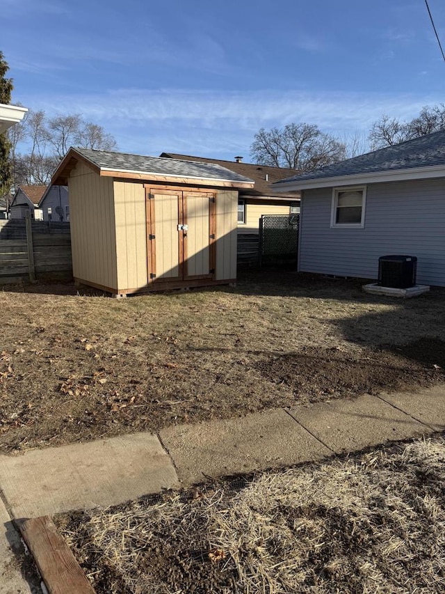 exterior space featuring cooling unit and a storage shed