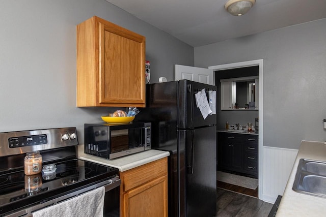 kitchen with dark hardwood / wood-style flooring, stainless steel appliances, and sink