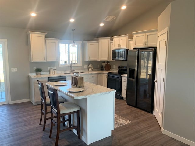 kitchen featuring black appliances, a kitchen island, white cabinets, and sink