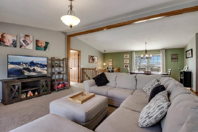 carpeted living room with a chandelier and lofted ceiling with beams