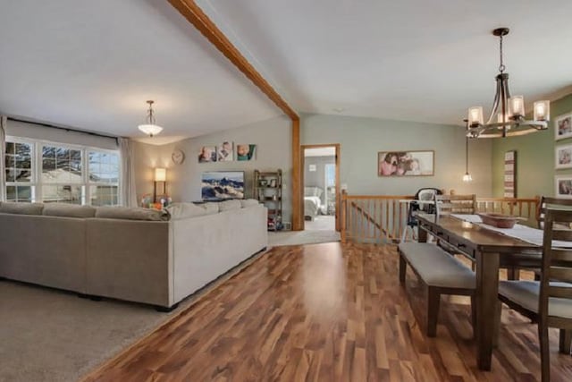 dining area with vaulted ceiling with beams, hardwood / wood-style floors, and a chandelier