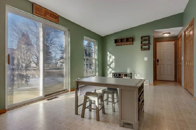 dining space with vaulted ceiling