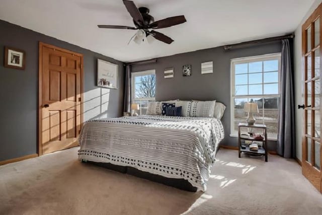 bedroom featuring ceiling fan and light colored carpet