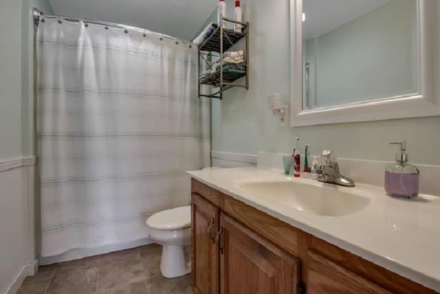 bathroom with tile patterned floors, a shower with curtain, vanity, and toilet