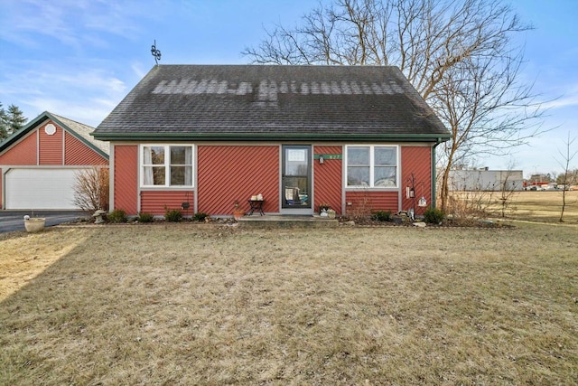 view of front facade with a front yard and a garage