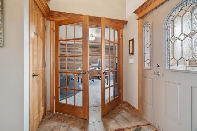 entrance foyer featuring french doors and baseboards