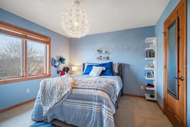 bedroom featuring baseboards, carpet floors, and an inviting chandelier