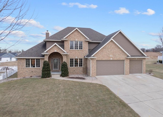 view of front of property with a front yard and a garage