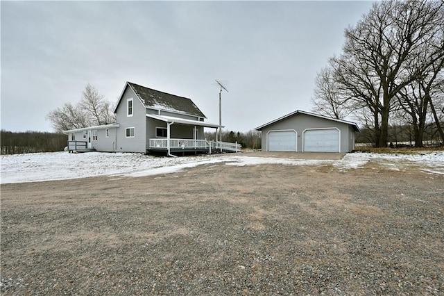 view of front facade featuring a garage and an outdoor structure