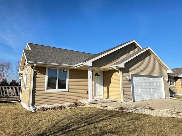 single story home featuring a front lawn and a garage