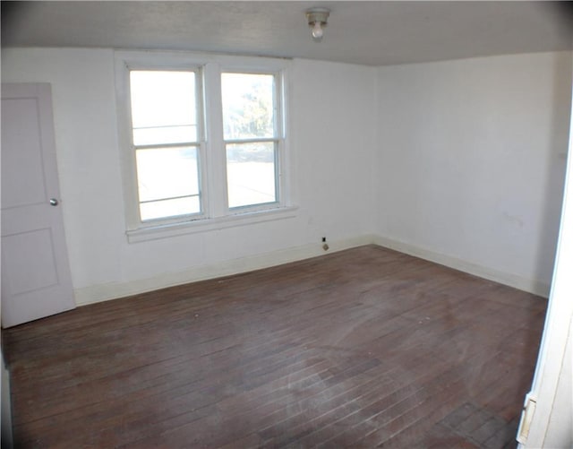 empty room featuring dark hardwood / wood-style flooring