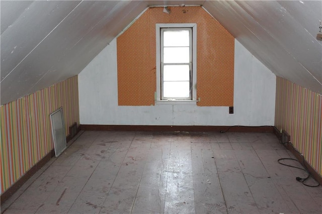 additional living space featuring hardwood / wood-style flooring and lofted ceiling