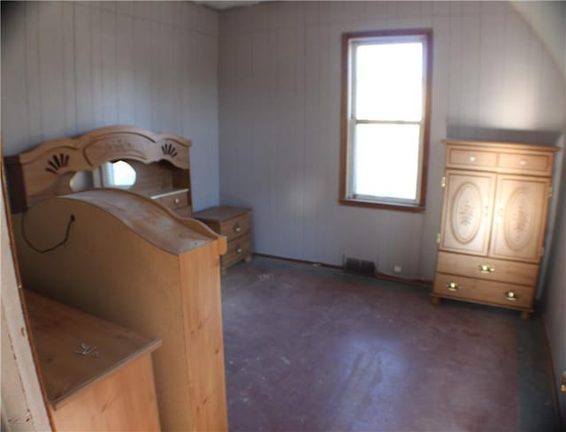 bedroom with wood walls