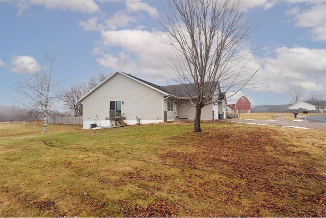 view of side of home with a lawn