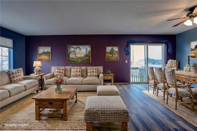 living room featuring wood-type flooring, a textured ceiling, ceiling fan, and a healthy amount of sunlight