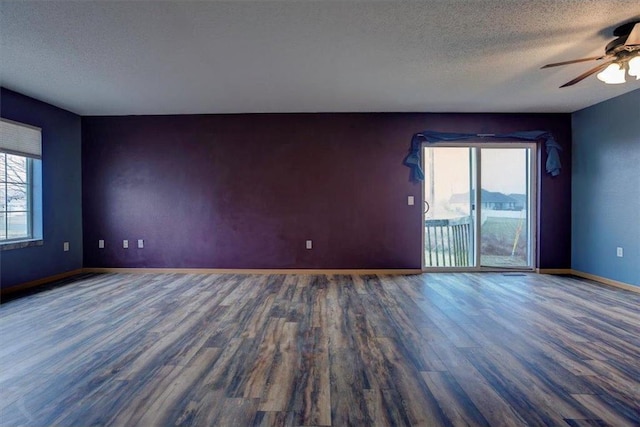 spare room with ceiling fan, dark hardwood / wood-style floors, and a textured ceiling