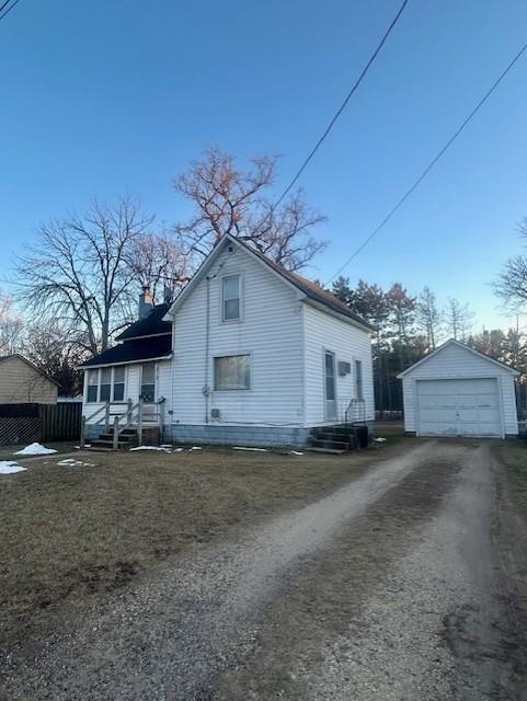 view of front of home with an outdoor structure and a garage