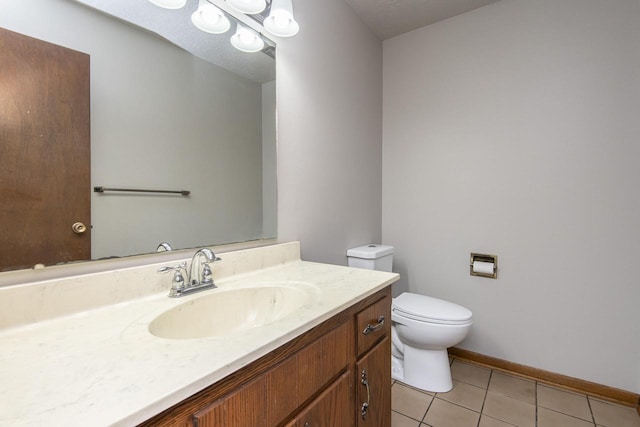 bathroom featuring toilet, vanity, and tile patterned floors