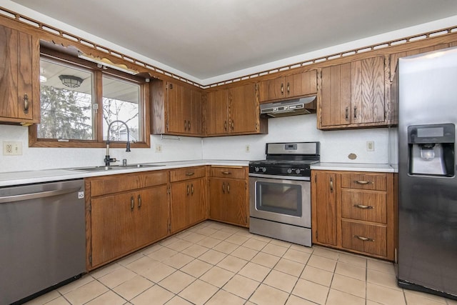 kitchen with sink, light tile patterned floors, and stainless steel appliances