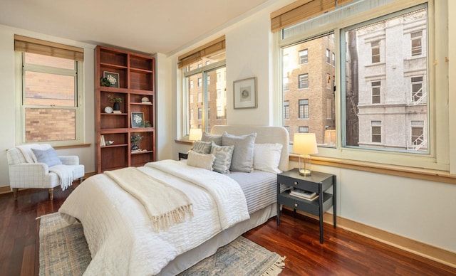 bedroom with dark hardwood / wood-style flooring