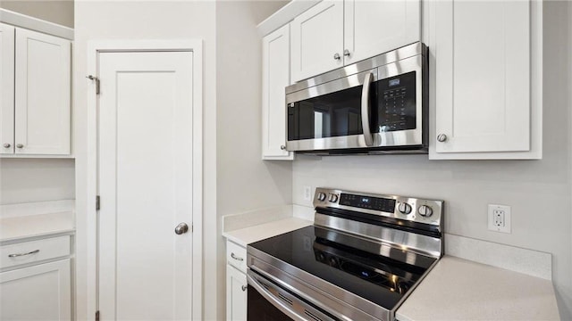 kitchen with white cabinetry and stainless steel appliances