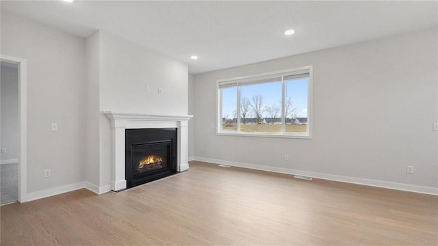 unfurnished living room featuring light hardwood / wood-style floors