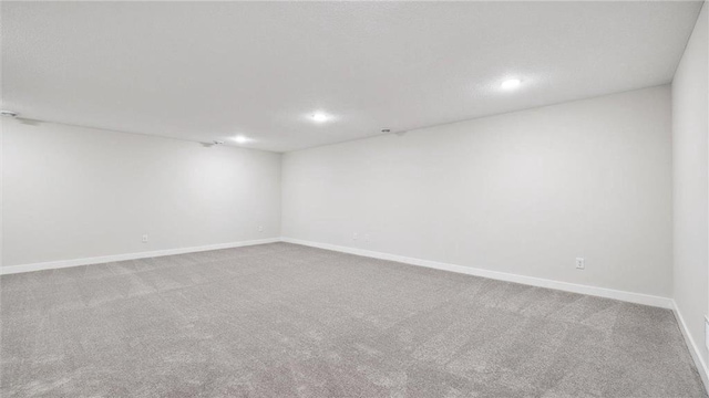 spare room featuring light colored carpet