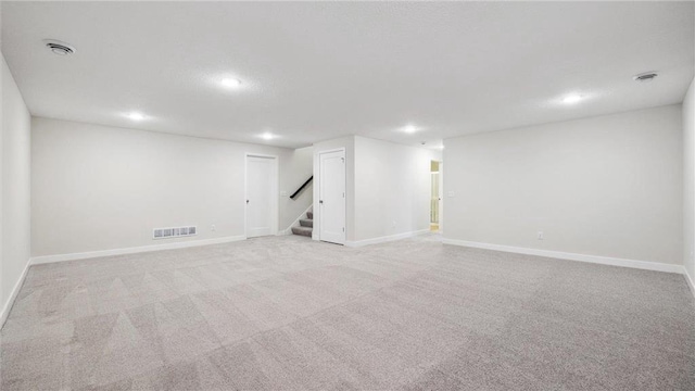 basement featuring light colored carpet