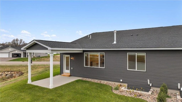 rear view of property with a lawn and a patio