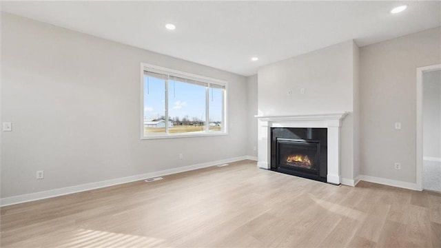 unfurnished living room with light wood-type flooring