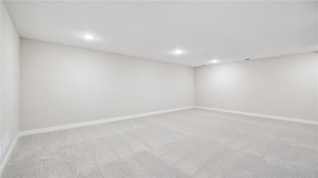 unfurnished room featuring light carpet