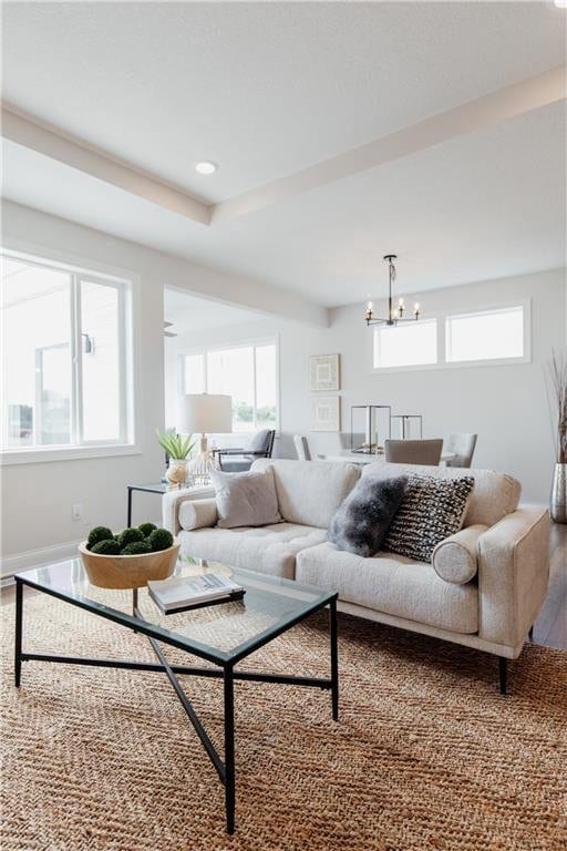 living room featuring an inviting chandelier and plenty of natural light