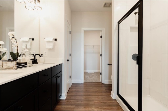 bathroom with vanity, hardwood / wood-style flooring, and walk in shower