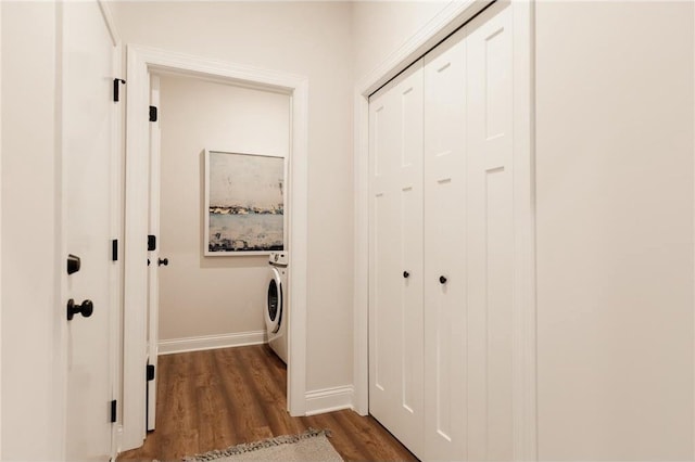 hall with washer / dryer and dark wood-type flooring